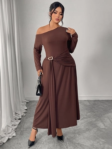 Close-up of side pleats and golden ring buckle detail on a brown off-shoulder dress