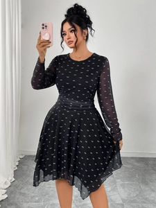 Detail of black dress featuring white bow patterns and semi-sheer chiffon sleeves