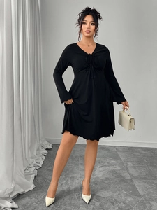 Detail of elegant black V-neck dress featuring sophisticated front drawstring lace-up design