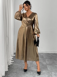 Close-up of metallic gold pleated wrap dress with lantern sleeves and V-neck detail