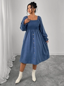 Detail of square neck dress with smocked bodice and decorative front buttons