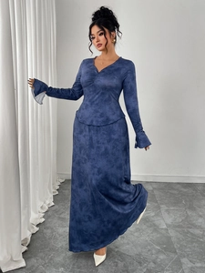 Detail of V-neckline with pleated design and flared split sleeves on a navy maxi dress