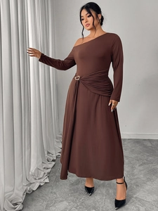 Detail of waist pleats and metal heart buckle on elegant brown off-shoulder dress