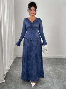Detail view of the V-neck and pleated waist design on this navy marble print long dress