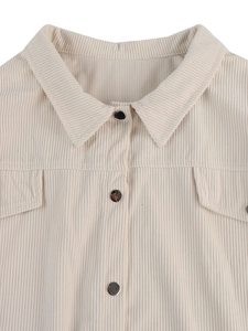 Detail of beige corduroy jacket showing lapel collar and metal buttons texture