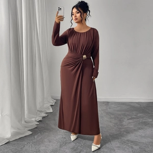 Brown long-sleeve maxi dress with round neck, cinched waist, and elegant gold buckle detail