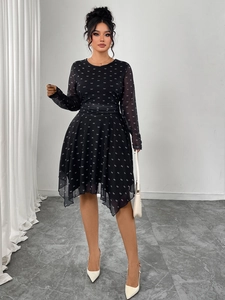Detail of black chiffon dress featuring white bow patterns and elegant layered hemline