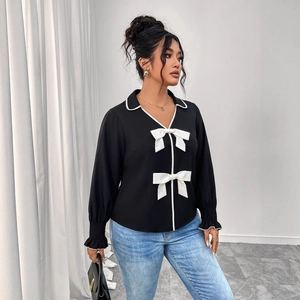 Elegant black polo-neck cropped jacket with white contrast trim and decorative bows