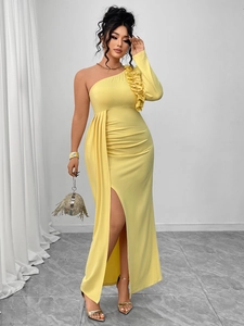 Detail of one-shoulder yellow evening dress with layered ruffles and high thigh slit