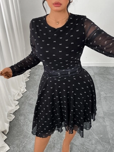Detail of black chiffon dress with white bow print and sheer mesh long sleeves