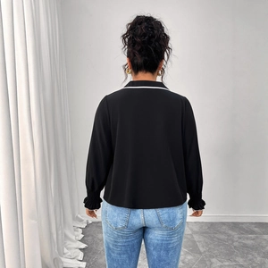 Back view of a black polo neck top with white contrast trim and pleated cuffs