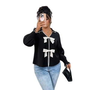 Women's black long-sleeve polo jacket with white ruffles and decorative bows