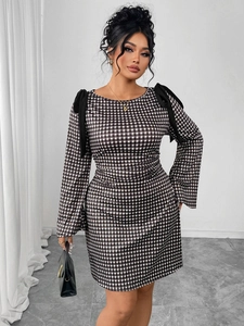 Detail of elegant black and white plaid dress featuring large shoulder bows and slim fit cut