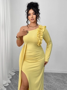 Detail of elegant yellow one-shoulder evening gown with ruffled shoulder and high side slit