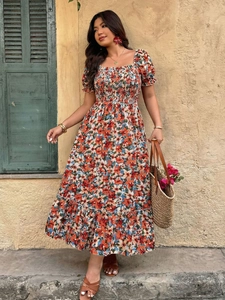 Close-up of floral midi dress featuring square neck, smocked chest, and puff sleeves