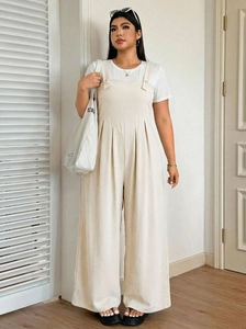 Detailed texture of beige wide-leg jumpsuit with cargo-style shoulder button and v-neck line