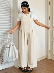 Detail of off-white wide-leg jumpsuit with V-neck stitching and pleated waist design