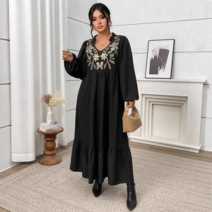 Plus size black maxi dress with elegant floral embroidery and ruffled hemline