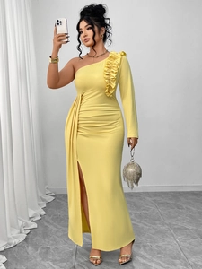 Detail of elegant yellow one-shoulder evening gown with ruffled neckline and high slit