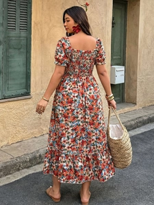 Detail of square neck floral dress with smocked back and puffed sleeves for summer