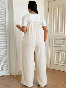 Back view of loose-fit beige wide-leg overalls paired with a white ribbed short sleeve T-shirt
