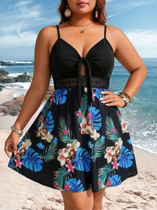 Detail of plus size swimsuit with V-neck tie, lace waist, and tropical floral print