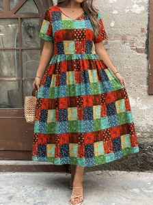 Detailed view of bohemian patchwork paisley pattern and V-neck button design on dress