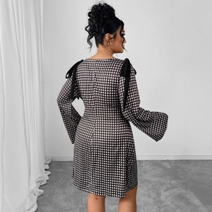 Slim fit plaid long sleeve dress with bow detail and bell sleeves on a back view model