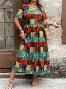 Detailed view of bohemian patchwork paisley print with buttons on a V-neck maxi dress