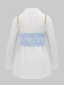 Detail view of the back of a white shirt with a tweed corset and golden chain straps
