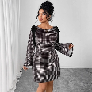 Slim fit black and white plaid dress with bow accents and elegant bell sleeves