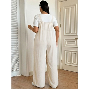 Women's cream wide-leg overall jumpsuit paired with a white short sleeve t-shirt