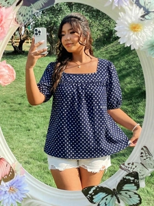Creative mirror selfie showing navy blue polka dot puff sleeve blouse in outdoor setting