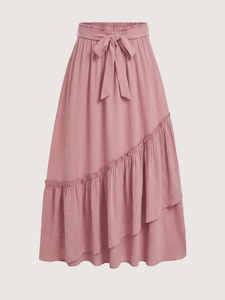 Detail of pink ruffled tiered skirt showing elastic waist with decorative bow tie
