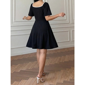 Plus size black A-line dress with square neck and white contrast trim back view