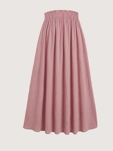 Detail of dusty pink skirt featuring elastic waist with drawstring and textured fabric
