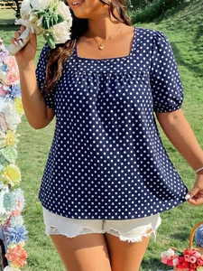 Detail of square neckline and puff sleeves on navy blue polka dot summer blouse