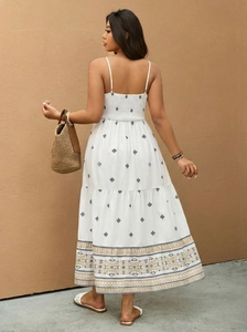 Back view of a plus-size white maxi dress with black geometric print and smocked back detail