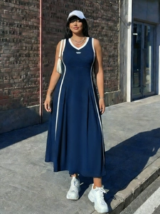 Dettaglio abito sportivo blu navy senza maniche con scollo a V bianco e strisce laterali
