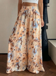 Detail of high waisted wide leg pants featuring artistic tie-dye print and drawstring waist