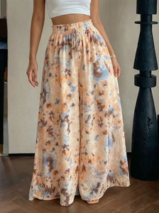 Detail of high-waisted tie-dye wide-leg pants with elastic drawstring waistband