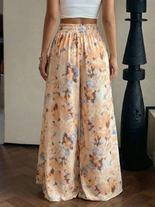Rear view of high waisted tie-dye wide leg pants with marble print and elastic waistband