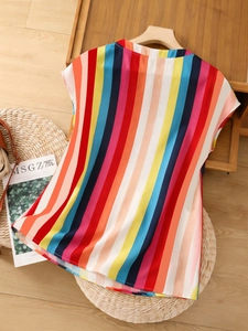 Flat lay of colorful striped chiffon top with V-neckline and ruffled sleeves on wooden hanger