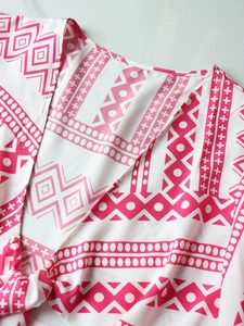 Detail of V-neckline and tie-front knot on pink and white geometric print resort top
