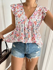 Detail of floral chiffon blouse featuring a V-neckline and tiered ruffle sleeves design