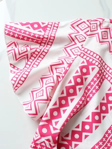 Detail of pink and white geometric print with ruffled sleeve edge on sun-protective top