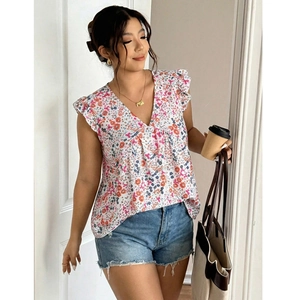 Detail of V-neck sleeveless chiffon blouse with pink floral prints and ruffle shoulders