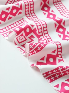 Macro shot of breathable fabric with pink geometric prints and neat white edge stitching