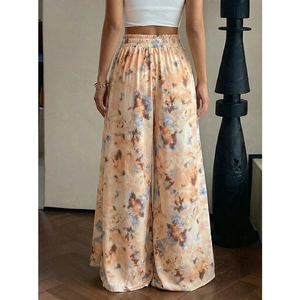 Women's high waist wide leg trousers featuring a vibrant orange and blue tie-dye print