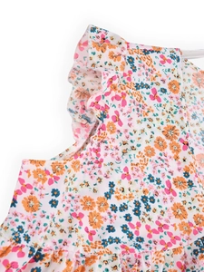Close-up detail of double-layered ruffles and colorful floral print on chiffon blouse